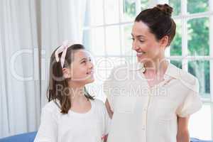 Mother and daughter smiling at each other