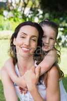 Mother and daughter smiling at camera