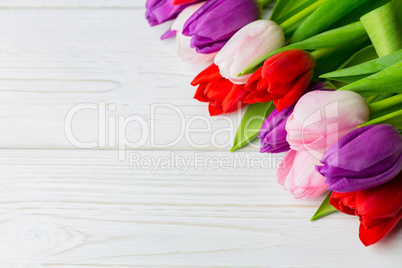 Colorful tulips on wooden table