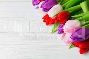 Colorful tulips on wooden table