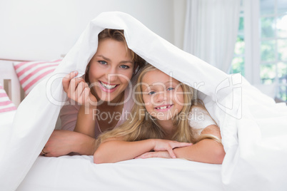 Mother and daughter smiling at camera