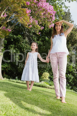 Mother and daughter holding hands