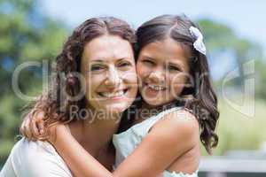 Happy mother and daughter smiling at camera