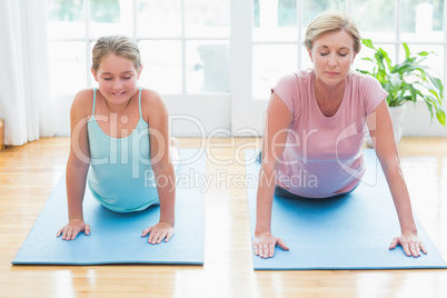 Mother and daughter doing yoga