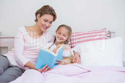 Mother with her daughter at bedtime