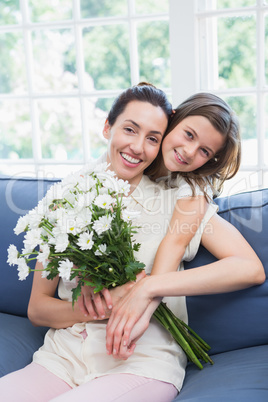 Mother and daughter smiling at camera