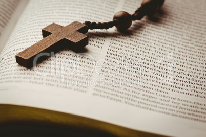 Open bible and wooden rosary beads