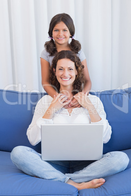 Happy mother and daughter smiling at camera