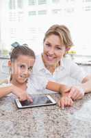 Mother and daughter using tablet pc