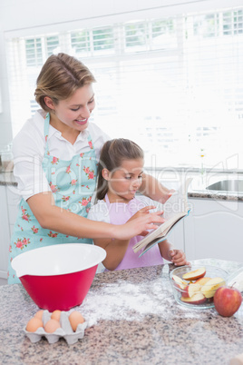 Mother and daughter baking together