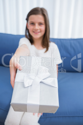 Little girl offering a silver gift