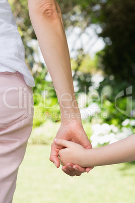 Mother and daughter holding hands