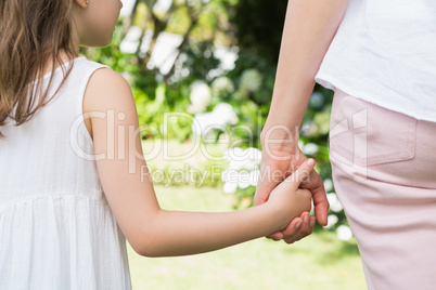 Mother and daughter holding hands