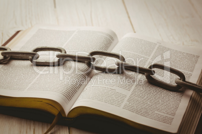 Open bible and heavy chain