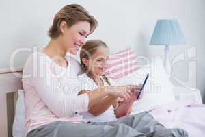 Mother and daughter using tablet pc