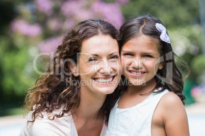 Happy mother and daughter smiling at camera