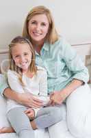 Happy mother and daughter smiling at camera