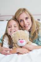 Happy mother and daughter smiling at camera