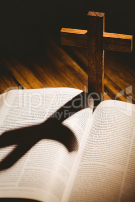 Open bible with crucifix icon behind