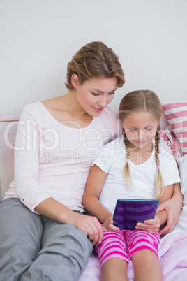 Mother and daughter using tablet pc