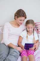 Mother and daughter using tablet pc