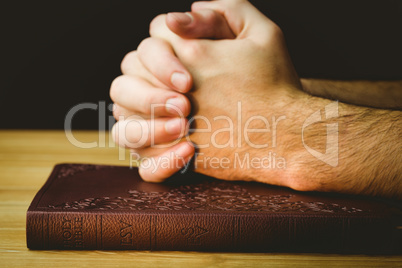 Man praying over his bible