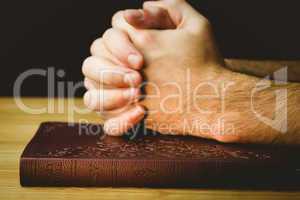 Man praying over his bible