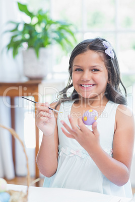 Cute girl painting easter eggs
