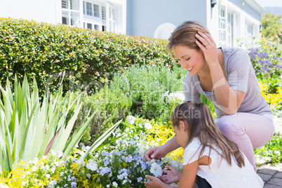 Mother and daughter tending to flowers