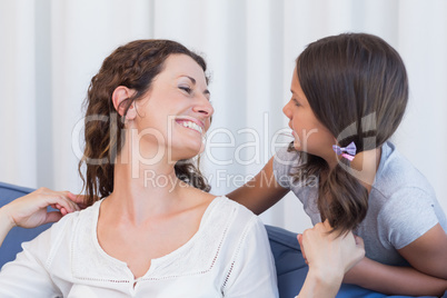 Happy mother and daughter smiling at each other