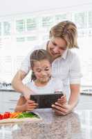 Mother and daughter preparing vegetables