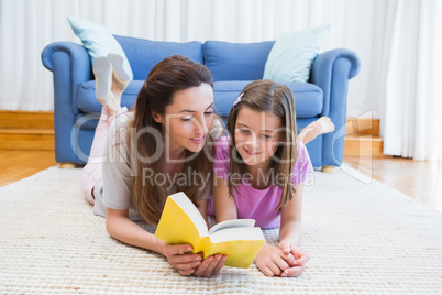 Mother and daughter reading on the floor