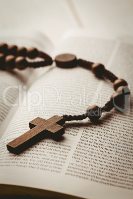 Open bible and wooden rosary beads