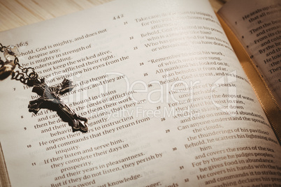 Open bible and silver crucifix