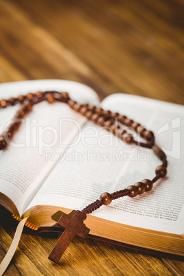 Open bible with rosary beads