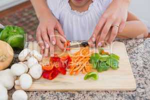 Mother and daughter preparing vegetables