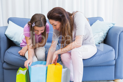 Mother and daughter looking at shopping bags