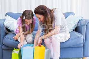 Mother and daughter looking at shopping bags
