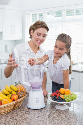Mother and daughter making a smoothie