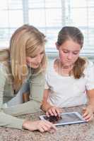 Mother and daughter using tablet pc together