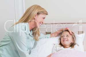 Happy mother and daughter smiling at each other