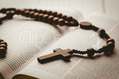 Open bible and wooden rosary beads