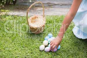 Little girl collecting easter eggs