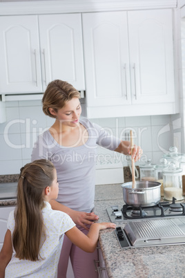 Mother and daughter cooking together