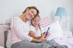 Mother and daughter using tablet pc