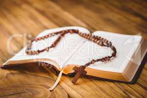 Open bible with rosary beads