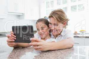 Mother and daughter using tablet pc