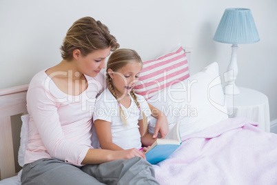 Mother with her daughter at bedtime