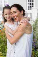 Mother and daughter smiling at camera