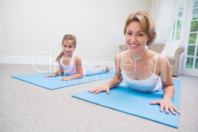 Mother and daughter doing yoga